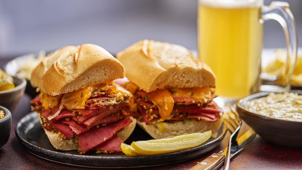 Regular Pastrami Sandwich · A classic sandwich with lean pastrami, yellow mustard, lettuce, tomato and crisp pickles on a toasted french roll, served with potato wedges.