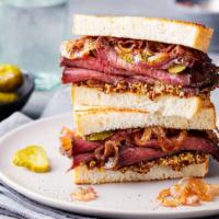 Pastrami and Roast Beef Hot Sandwich · Thinly sliced pastrami and fresh roast beef, swiss cheese topped with poppy seeds, served wi...
