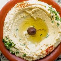 Hummus · A delicious middle eastern blend of chickpeas, tahini, fresh garlic, lemon & olive oil.