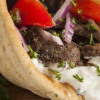 Regular Gyro · Seasoned lamb/beef meat cooked on rotisserie. Contains fresh lettuce, tomato, onions, and sp...