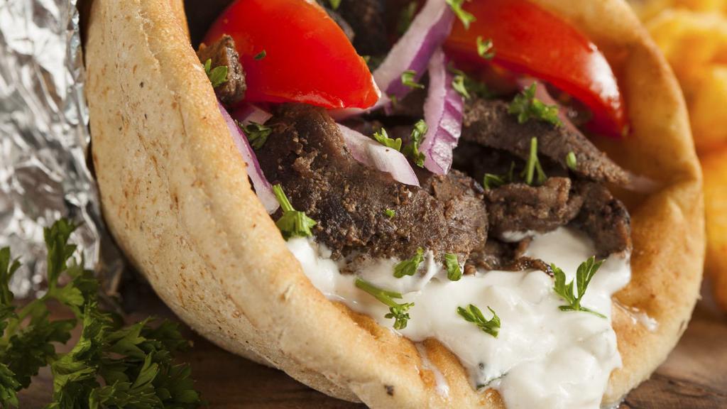 Regular Gyro · Seasoned lamb/beef meat cooked on rotisserie. Contains fresh lettuce, tomato, onions, and special yogurt sauce wrapped in warm pita bread.