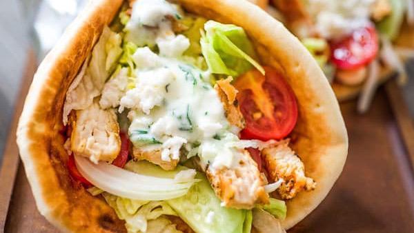 Chicken Gyro · Seasoned chicken meat cooked on rotisserie. Contains fresh lettuce, tomato, onions, and special yogurt sauce wrapped in warm pita bread.