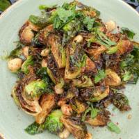 Crispy Brussels Sprouts · Savory onion caramel, lime, mint, roasted garlic, marcona almonds.