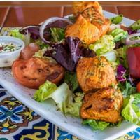 Chicken Kabab · Marinated chicken cubes, charbroiled, lettuce, garlic sauce, and seasonal grilled vegetables...
