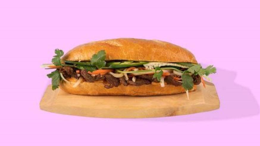 Grilled Steak Banh Mi · Grilled steak on a baguette with fried egg, cucumber,  jalapeño,  pickled carrot, cilantro, green onion.