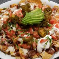Super Nachos · Your choice of meat serve on chips with cheese, guacamole, pico de gallo, beans, sour cream ...