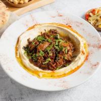 Hummus Bowl with Braised Lamb (GF) by Oren's Hummus · By Oren's Hummus. Hummus topped with slow braised hand pulled lamb shoulder topped with mint...