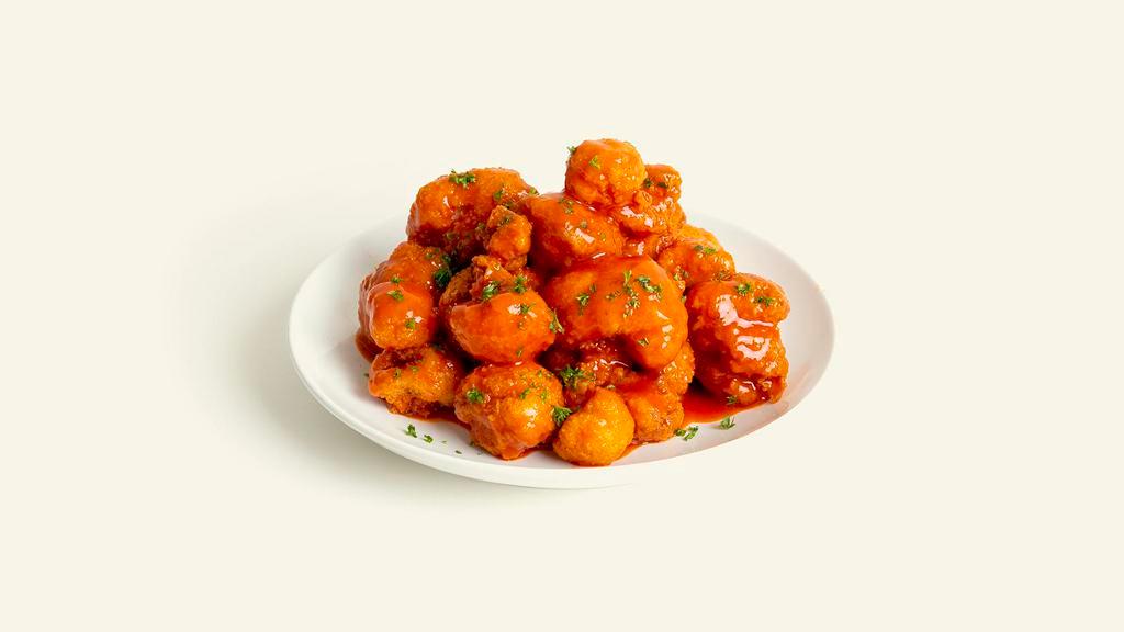 Cauliflower Wings · Crispy bites of cauliflower coated in buffalo sauce and served with celery and vegan ranch.