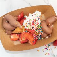 The Fat Cannoli · Deep-fried cannoli shell filled with handcrafted chocolate gelato with fresh strawberries, w...