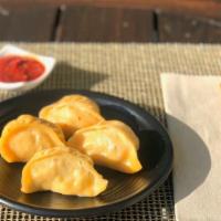 Kimchi & Pork Dumpling · Our newest dumpling fuses asian staples of kimchi and pork dumplings. Red chili sauce has be...
