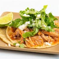 Chicken Tinga Taco · lettuce, cotija cheese, crema.  All tacos served with three signature salsas.