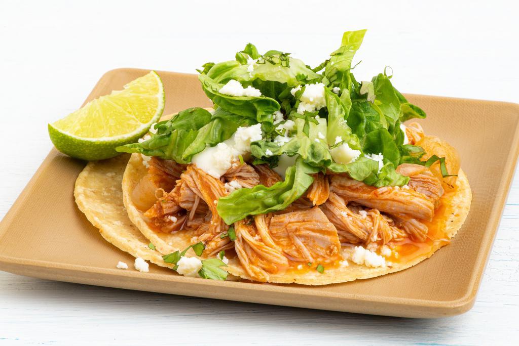 Chicken Tinga Taco · lettuce, cotija cheese, crema.  All tacos served with three signature salsas.