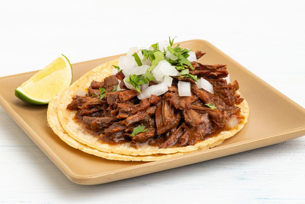 Guajillo Braised Beef Taco · chipotle, cumin, mexican oregano.  All tacos served with three signature salsas.