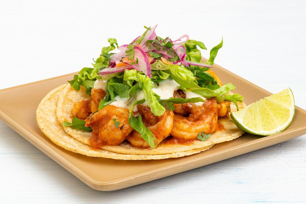 Spicy Shrimp Taco · morita-arbol salsa, crema, lettuce, habanero-onion pickles.  All tacos served with three signature salsas.