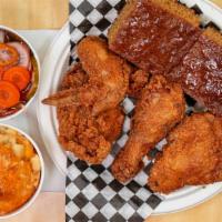 Combo 2 · Four pieces fried chicken, cornbread and two small sides.