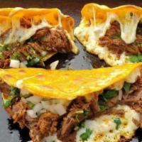Quesa Asada · Quesabirria-style taco. Corn tortilla dipped in our house chili oil, filled with a melted bl...