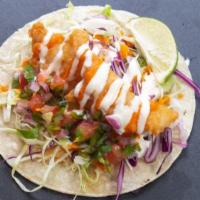 Baja Fish · Fried white fish tacos topped with cabbage, baja crema, spicy street sauce and pico de gallo.