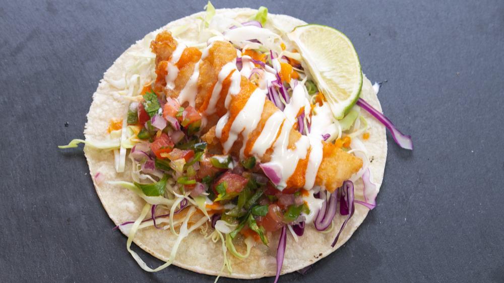 Baja Fish · Fried white fish tacos topped with cabbage, baja crema, spicy street sauce and pico de gallo.