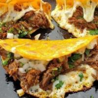 Quesa Pollo · Quesabirria-style taco. Corn tortilla dipped in our house chili oil, filled with a melted bl...