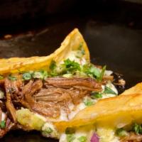 Quesa Carnitas · Quesa style pulled pork taco.
