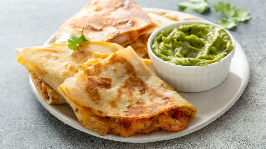 The Shrimp Quesadilla · Freshly prepared, warm flour tortilla filled with perfectly seasoned grilled shrimp, gooey Monterey jack cheese and salsa fresca. Served with a side of sour cream and guacamole.