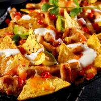 Mas Nachos with Carne Asada · Hot & Crisp Mexican-style chips topped with perfectly seasoned shredded steak, and a generou...