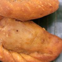 Empanada · 2 pieces of fried pastry with raisins and vegetable filling with choice of ground chicken or...