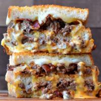 Double Burger With Bacon Grilled Cheese  · Crumbled burger meat topped with bacon, American and provolone cheese, caramelized onions, p...