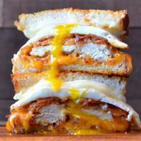 Dilemma Grilled Cheese · Hand-breaded chicken breast topped with a fried egg, crispy bacon, provolone and cheddar che...