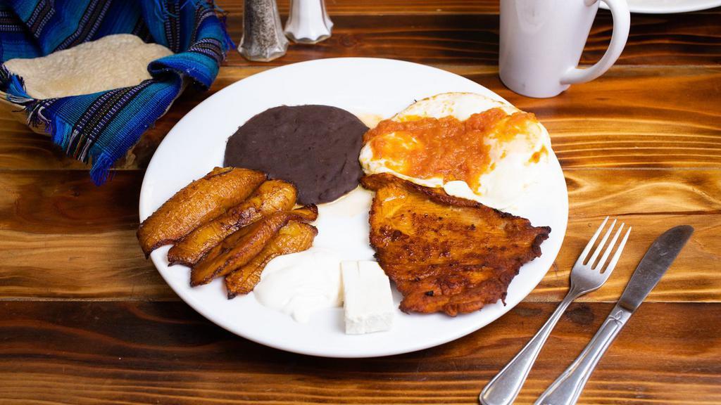Super breakfast · A slice of adobada meat (pork) 2 sunny side eggs, beans, fried plantains, sour cream, fresh cheese, 2 handmade tortillas