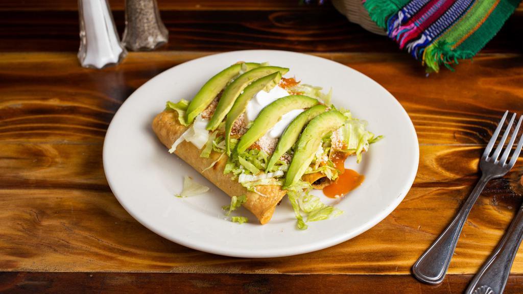 3 tacos dorados · Fried roll tortillas stuffed with chicken, potato, peas, and carrots, topped with lettuce, tomato sauce, cheese, sour cream, and avocado slices