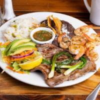 Super Churrasco Chapin · Carne Asada, shrimps, salad, refried beans with cheese and chips on top, rice,   green onion...