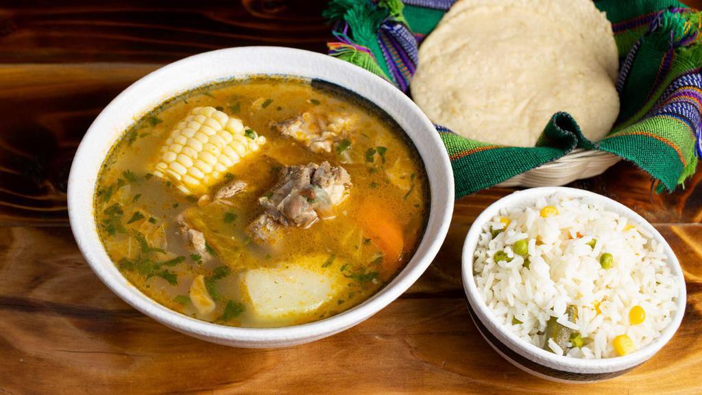 Caldo de Res · Beef soup with some vegetables ( corn on the cob, yuca, cilantro carrots, chayote, potato) served with rice and hand made tortillas on the side