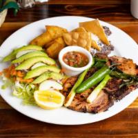 Chuleta a la plancha · Sliced of grilled pork chop, casamiento ( refried black beans mixed with rice) salad, fried ...