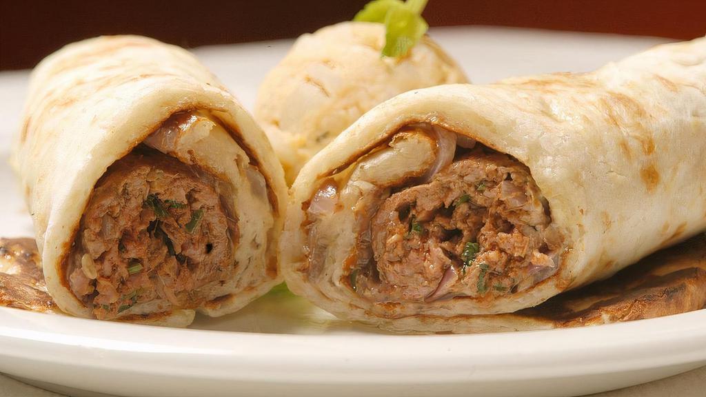 Spicy Seekh Kabob Wrap · Ground lamb kabob seasoned with green chili, ginger, and spices alongside onions, cilantro, and mint chutney. All wraps are made on a naan with mint-mayo