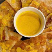 Roti with Curry Sauce · Fried Indian thin bread served with curry sauce.