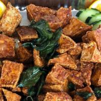 Spicy Crispy Tofu · Crispy-fried tofu coated with Thai chili paste topped with crispy basil leaves.
