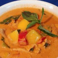 Mango Curry · Sweet mango in red curry paste and coconut milk, tomatoes, peas, and carrots, basil leaves, ...
