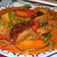 Roasted Duck Curry · Roasted duck in red curry, pineapples, bell peppers, tomatoes, peas, and carrots, sweet basil.