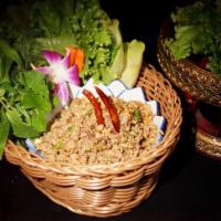Larb Duck Pakxe · Pakxe style spicy duck lettuce wrap + toasted rice powder soft herbs