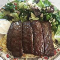 20. Gyros Plate · Five strips of grilled beef and lamb gyros served with rice pilaf, Greek salad, and tzatziki.