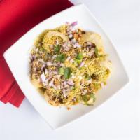 Sev Puri · Vegan. Flat shells filled with mashed potatoes, onions, spices, sev and chutneys.