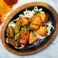 Tandoori Platter · Tandoori chicken tikka, spicy seekh kabab, and tandoori salmon topped with onions, cilantro,...
