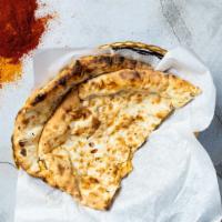 Paneer Naan (Cheese) · Indian bread stuffed with spiced cottage cheese and cooked in a clay oven.