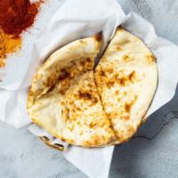 Butter Naan · Oven lovin' with freshly baked bread in a clay oven garnished with butter.