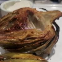 Artichoke · One whole artichoke trimmed and steamed until tender. Halved, the sautéed in EVOO served wit...
