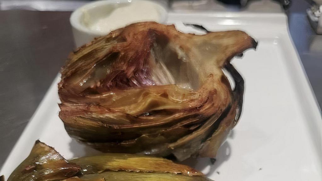 Artichoke · One whole artichoke trimmed and steamed until tender. Halved, the sautéed in EVOO served with a Tarragon Dip.