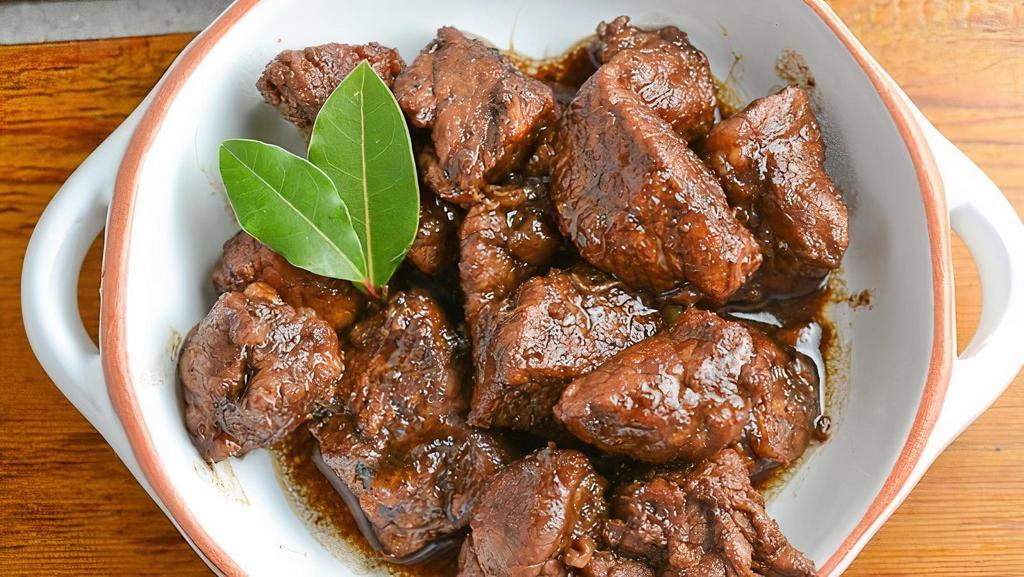Adobo (Pork) · Pork and Quail Eggs braised in vinegar, soy sauce, garlic, bay leaves, black peppercorns and spices until it develops sweet, salty and tangy flavors.
