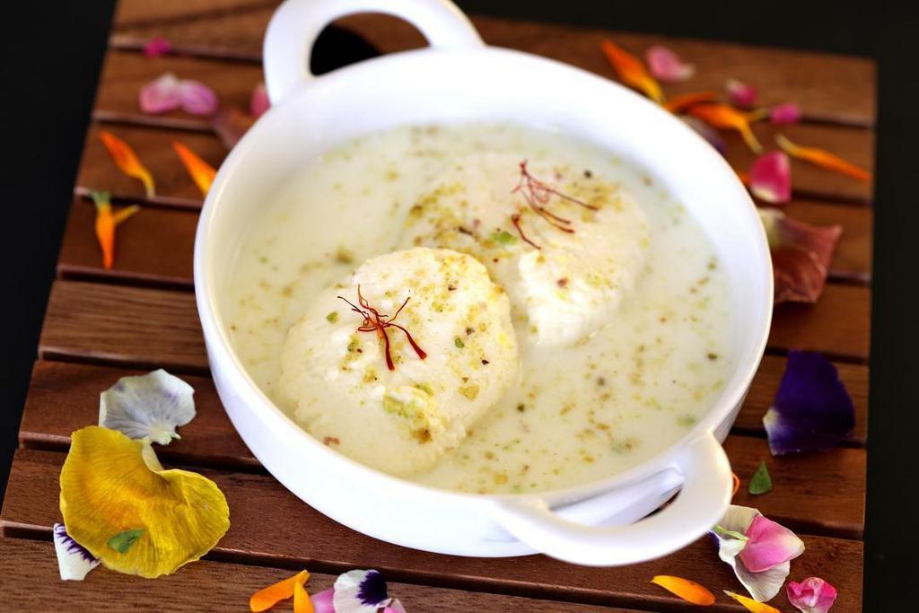 RASMALAI · CHEESECAKE DUMPLING in Malai Sauce served with a garnish of pistachio and almonds