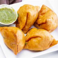 Veggie Samosa · Two pieces Lightly spiced pocket stuffed with peas and potatoes.